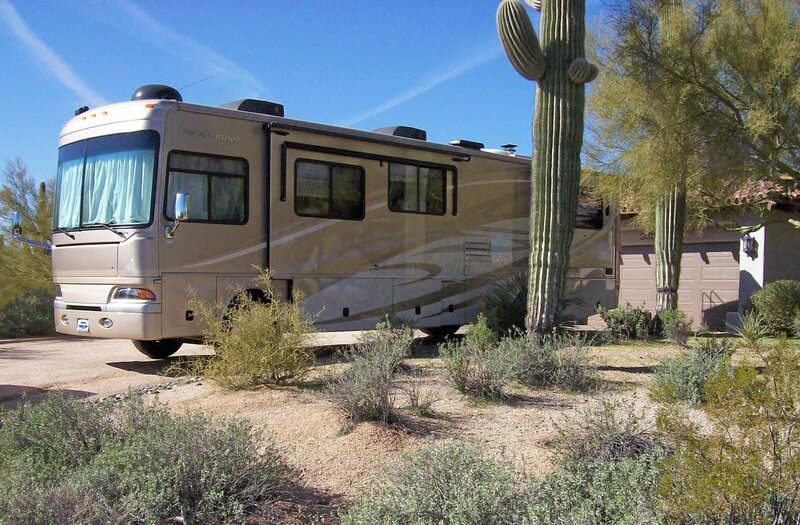 2008 diesel pusher Class A motorhome by saguaro cactus in Arizona driveway