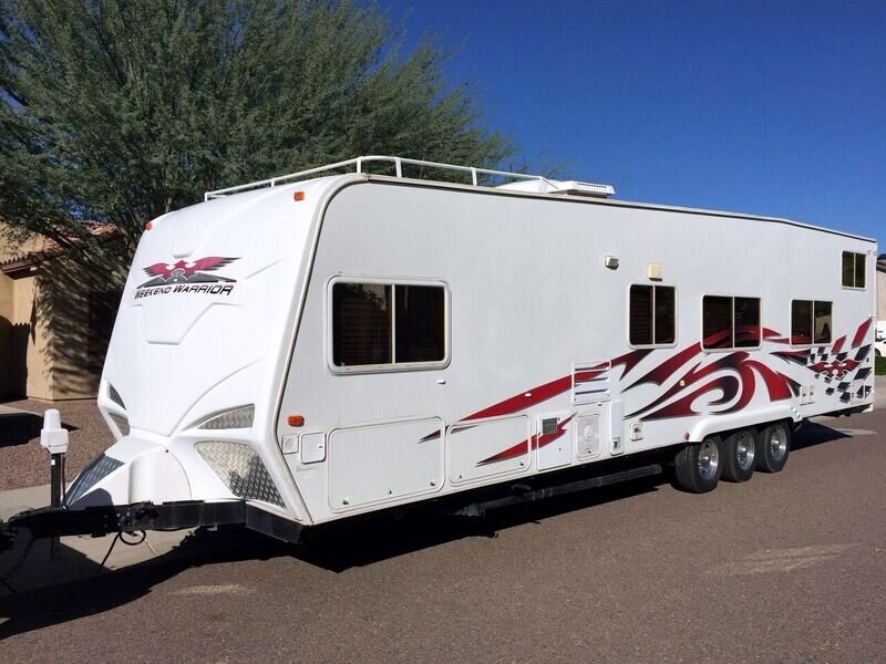 2016 Weekend Warrior toy hauler, triple axle, in an Arizona driveway