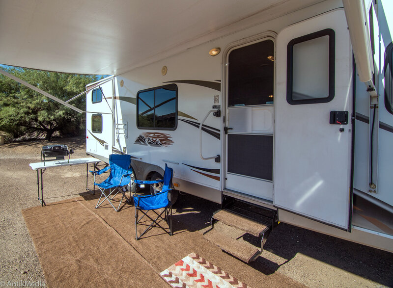 Travel trailer with awning and camp chairs at an Arizona campsite, 2016